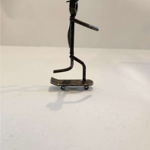 Metal guy on skateboard made by disabled veteran 3x5x2